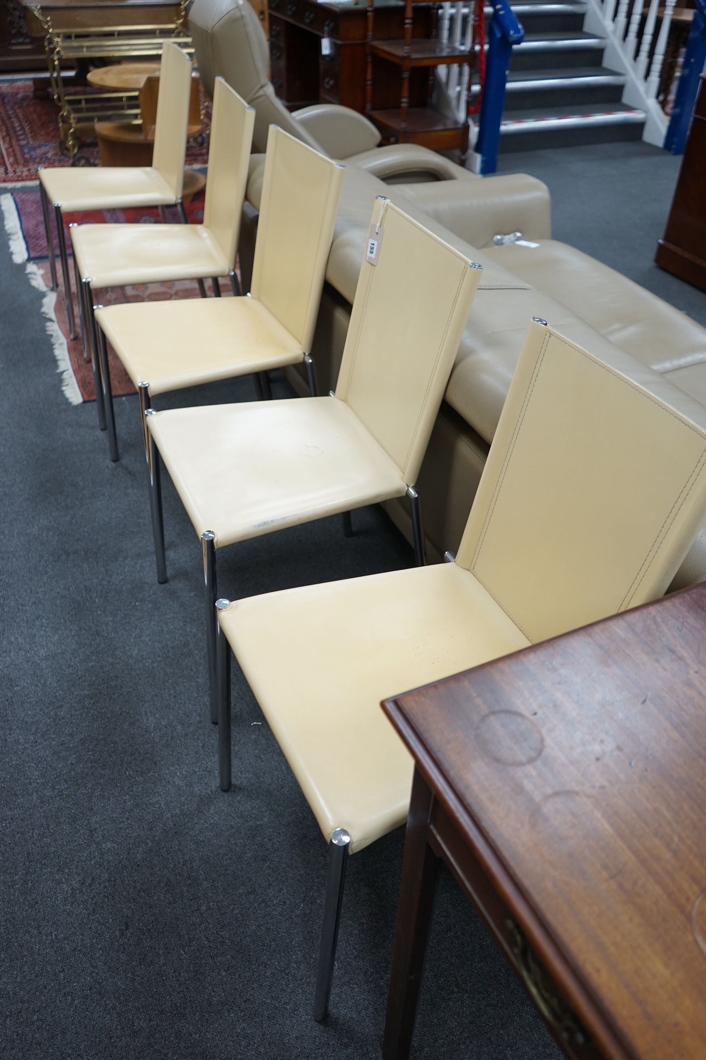 A set of five Italian cream leather and chrome dining chairs
